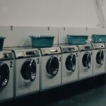 a row of washers and dryers in a room