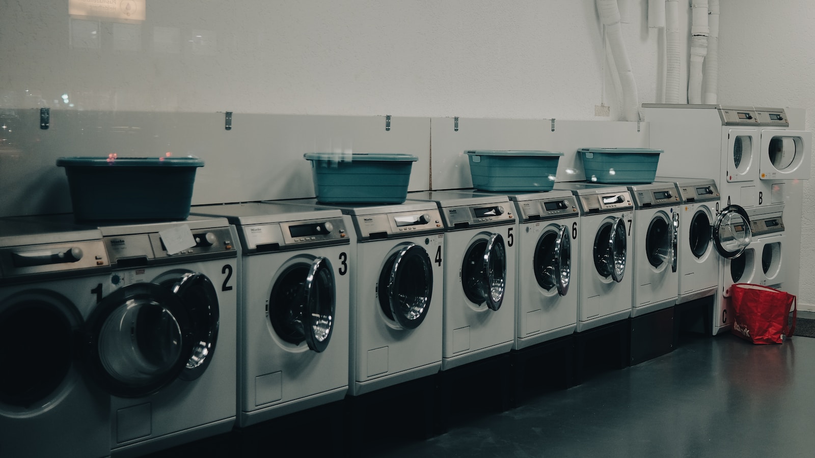 a row of washers and dryers in a room